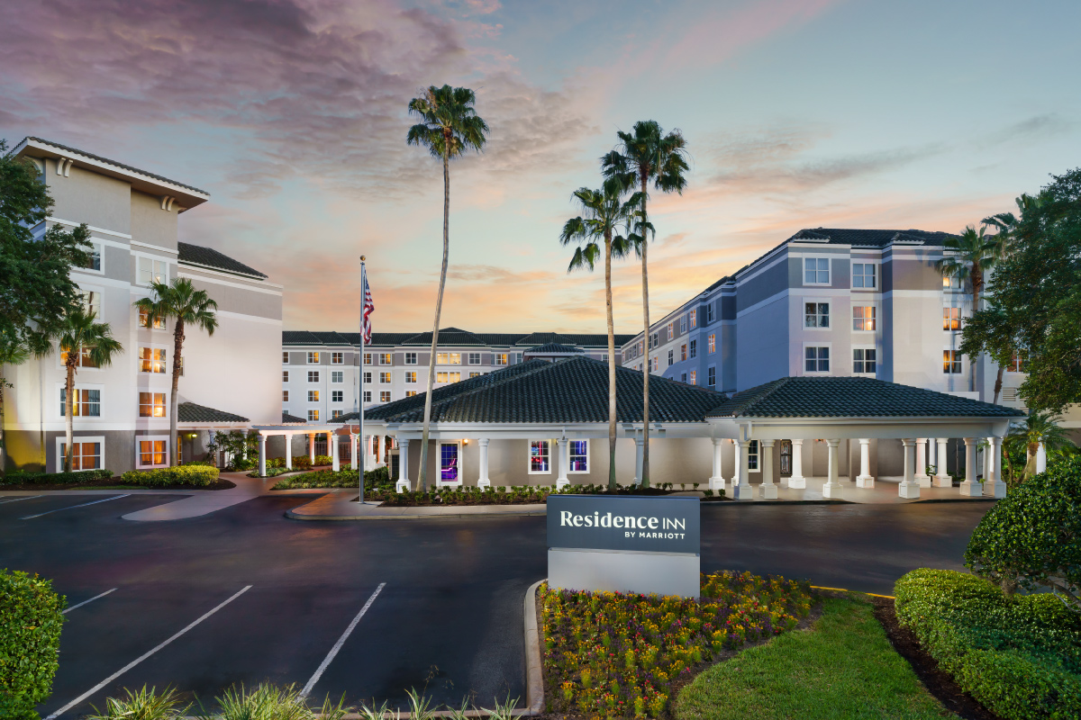 Exterior view of the residence inn with palm trees and parking