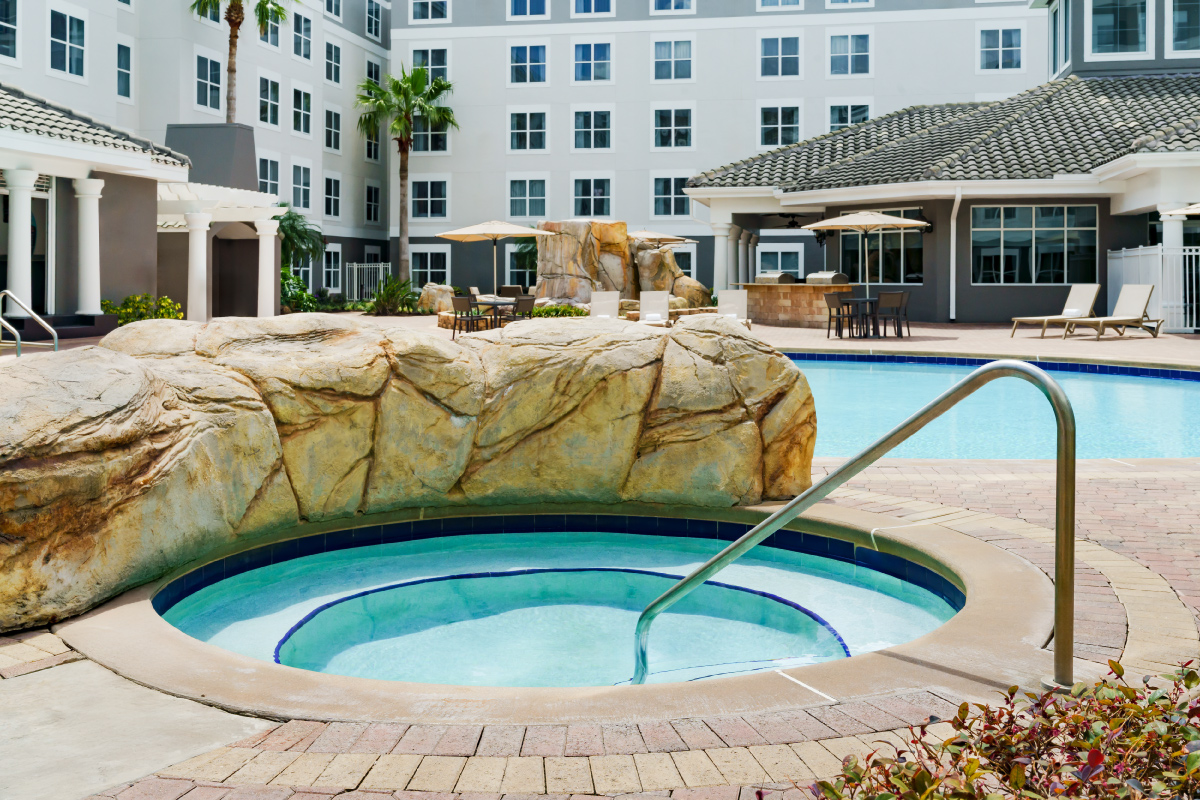 hot tub with stone wall separating from the main pool