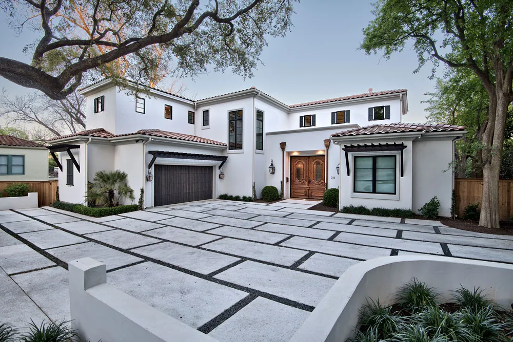 California Mediterranean residence with white stucco siding and arched openings
