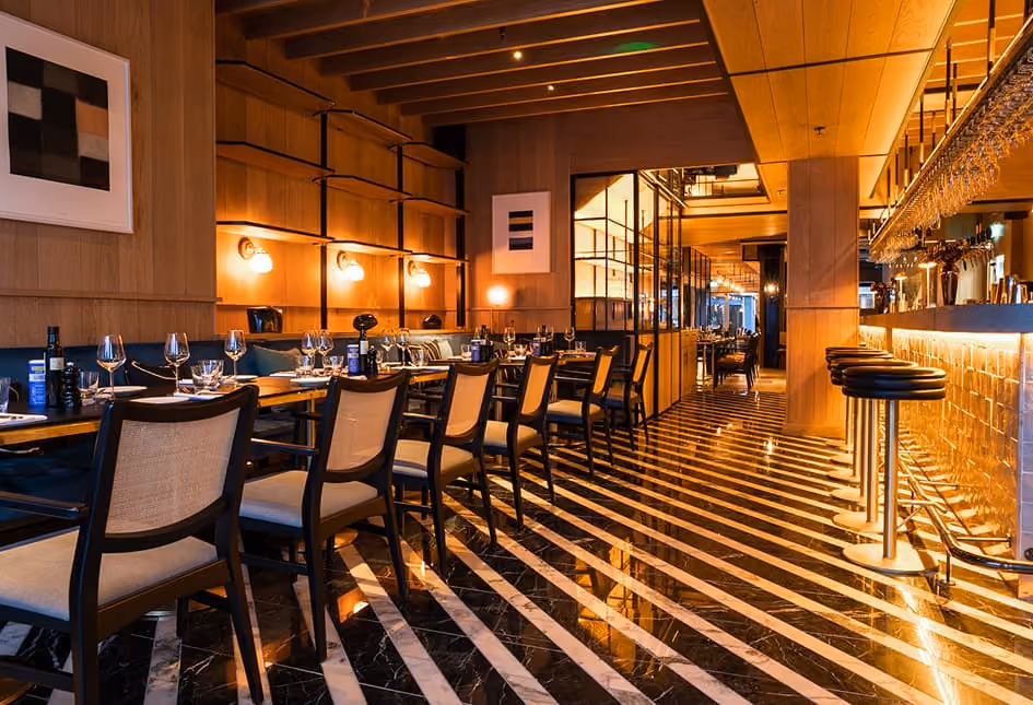 The dining room at Isabelle's with bar seating and a striped floor
