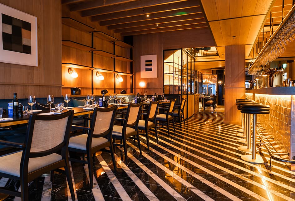 The dining room at Isabelle's with bar seating and a striped floor