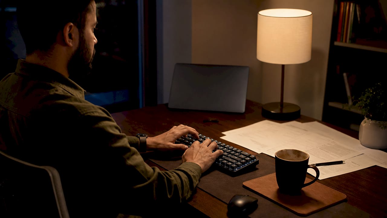 Hands typing payment API code at desk