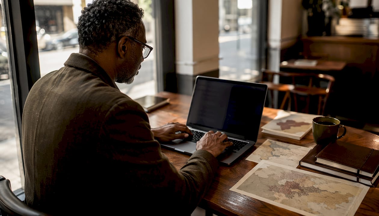 Hands typing in fintech compliance workspace