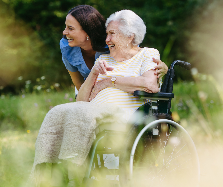 A caregiver and resident enjoying a sunlit garden together