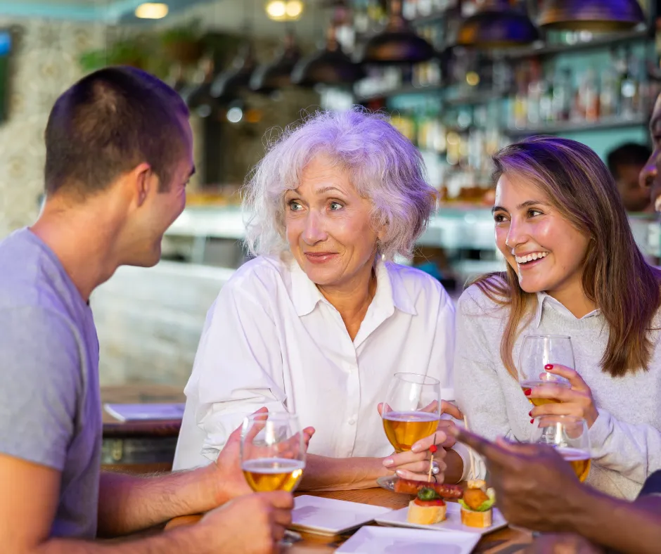 Friends enjoying drinks and conversation at a bar