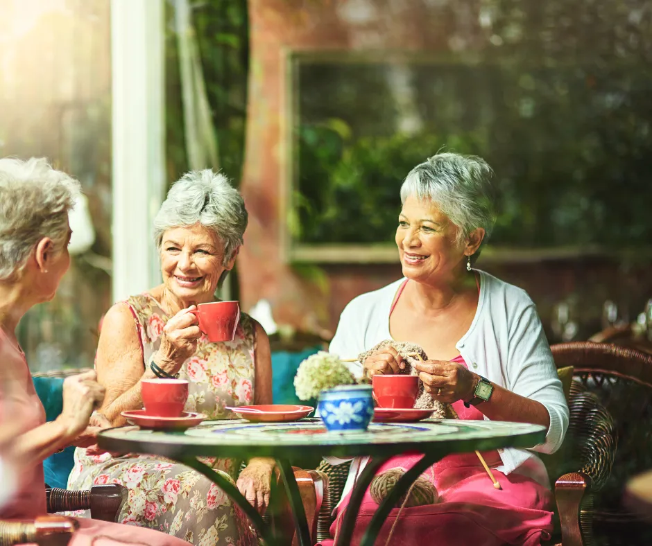 Friends sharing tea and conversation together on a garden patio