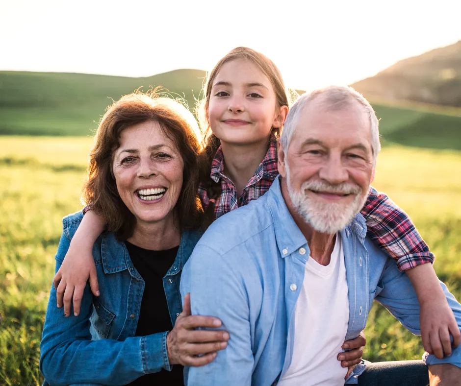 Three generations of a family together in a sunlit meadow near Coeur d'Alene