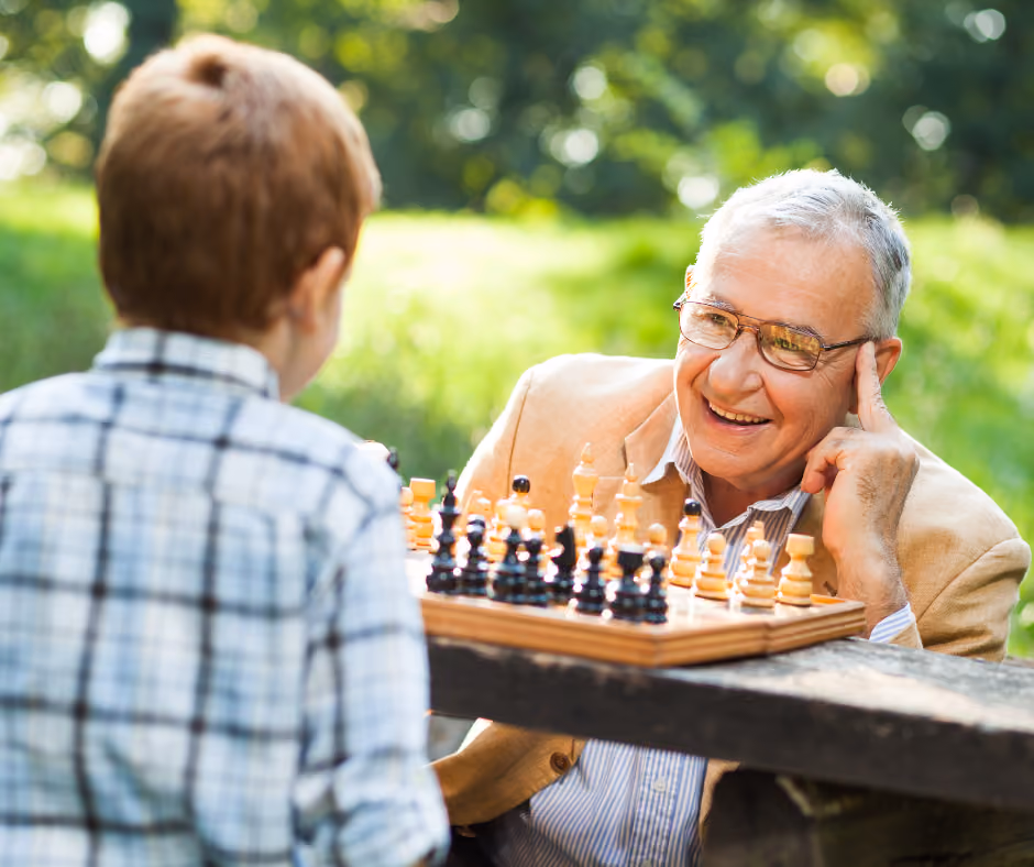 A resident sharing a game of chess outdoors