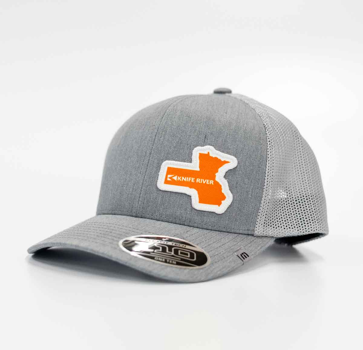 Gray trucker hat with a mesh back and a patch on the front showing an orange shape and the text 'Knife River'.