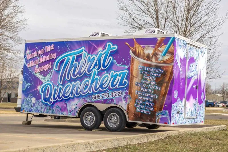Purple food truck with large text 'Thirst Quencherz' and phone number 605.770.3539, displaying a large iced coffee with a straw and a menu listing hot and cold coffee, latte, frappe, slushys, lemonade, hot tea, iced tea, boba tea, smoothies, soda, water, sports drinks, and mocktails. Text on side reads 'Quench your Thirst with our Refreshing Beverages!'.