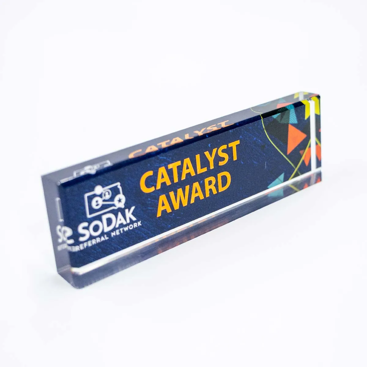 Rectangular glass award with the words 'CATALYST AWARD' in yellow on a dark blue background and the SoDak Referral Network logo on the left side.