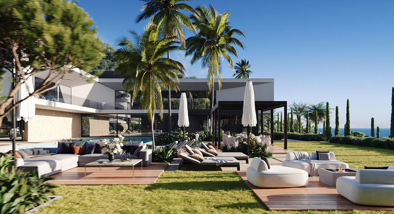 Modern outdoor lounge area with couches, sunbeds, palm trees, and ocean view under a clear sky.