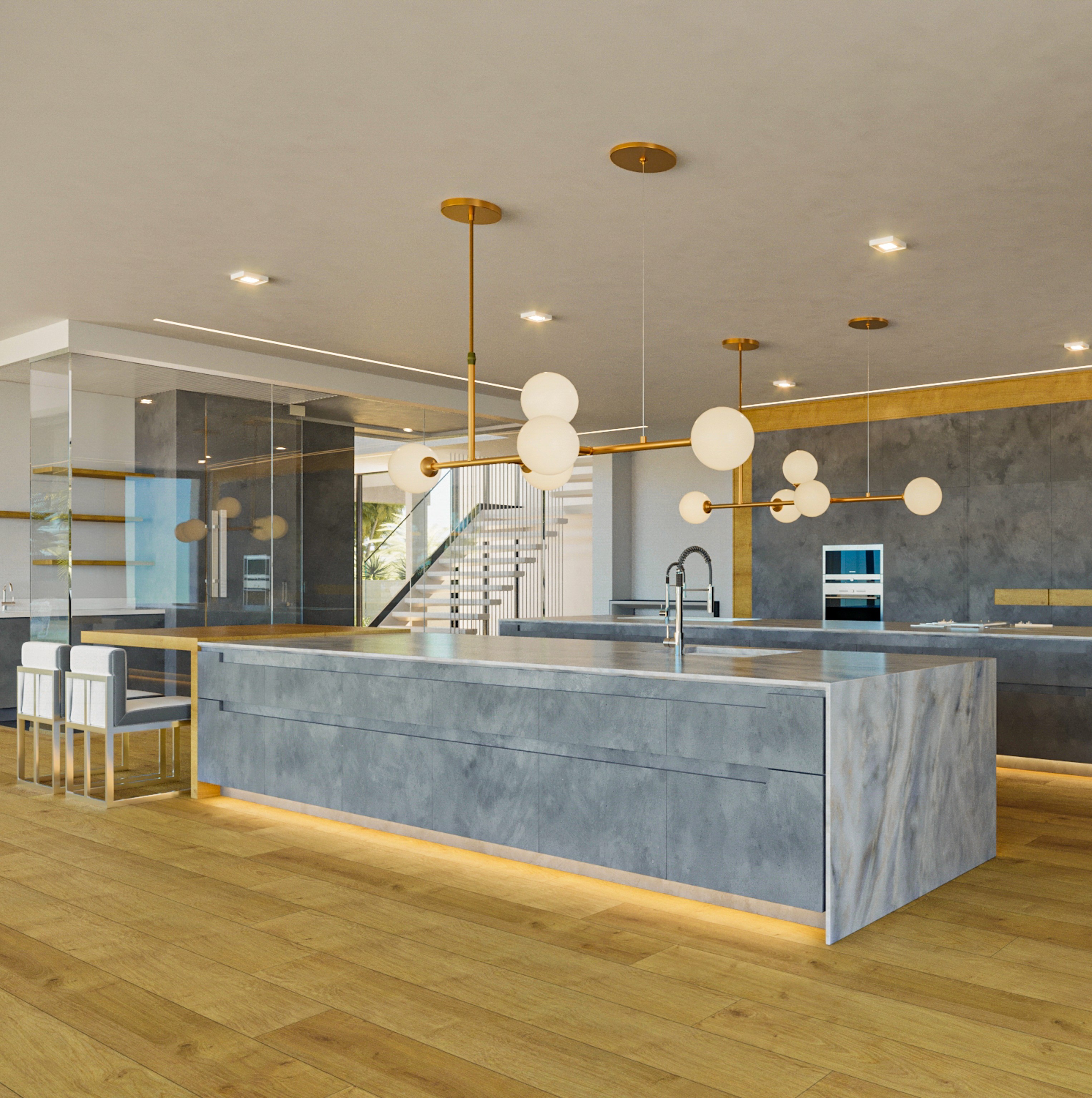 Modern kitchen with large gray marble island, gold lighting fixtures, wooden floor, and glass wall.