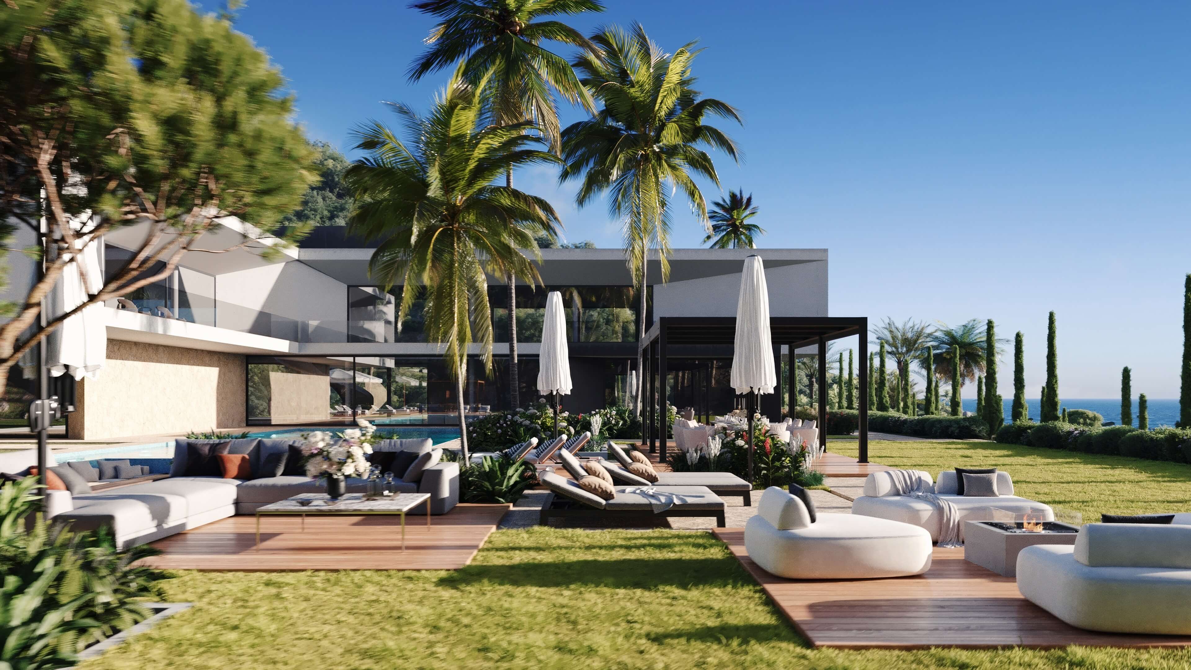 Modern outdoor lounge area with couches, sunbeds, palm trees, and ocean view under a clear sky.