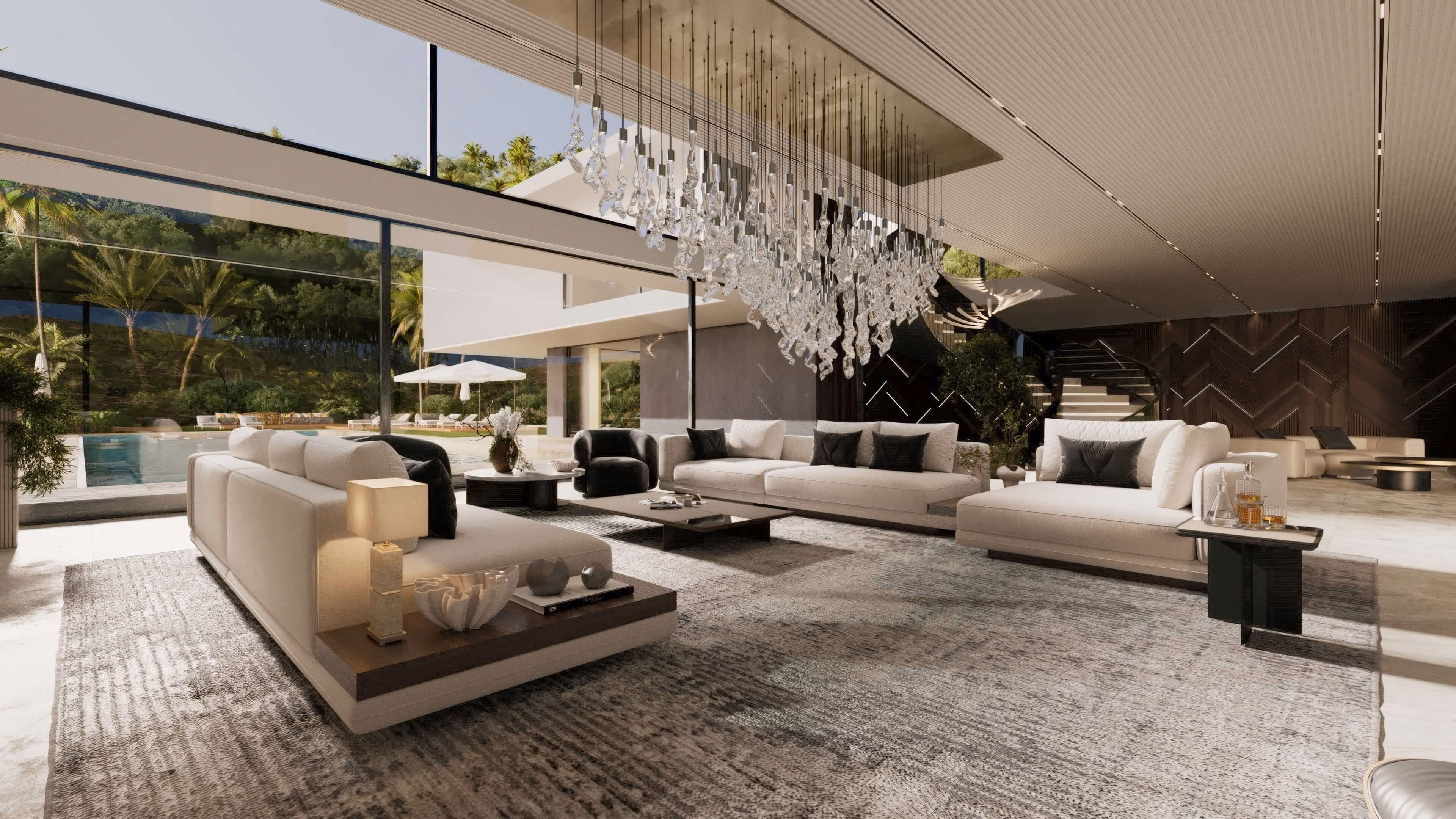 Spacious modern living room with large beige sofas, black cushions, a textured rug, glass coffee tables, a unique hanging glass chandelier, and floor-to-ceiling windows overlooking a pool and outdoor greenery.