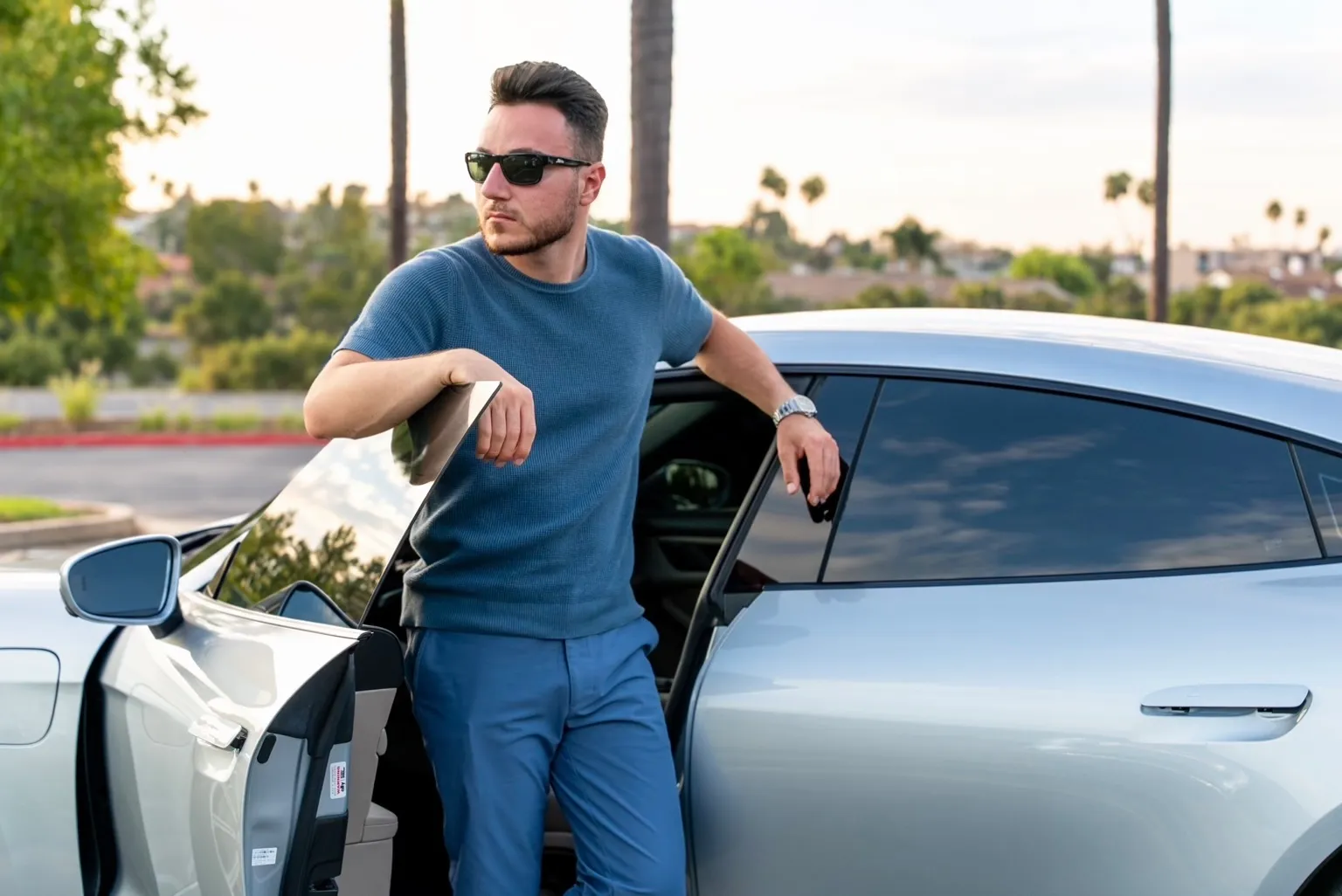 Joseph Hanna, founder of Joseph Hanna Development, standing beside an open car door.