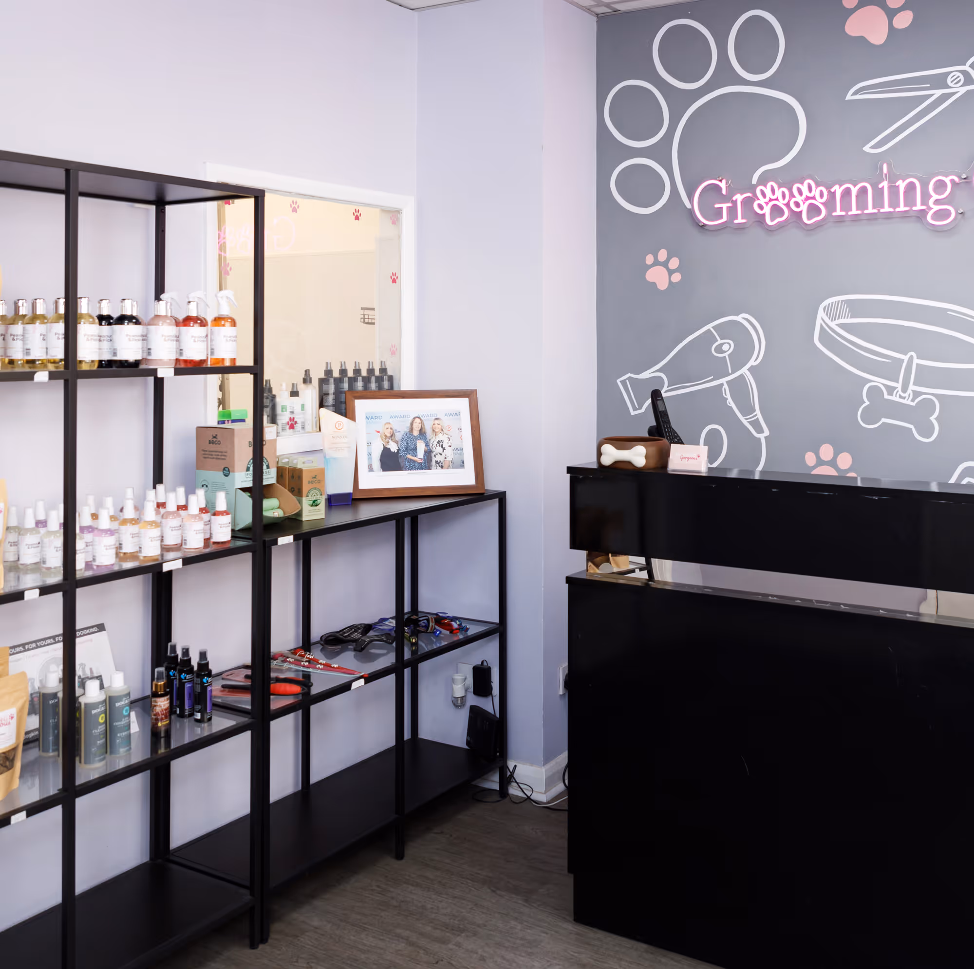 Inside the Grooming Gorgeous salon in Sunbury-on-Thames with retail shelves and neon sign