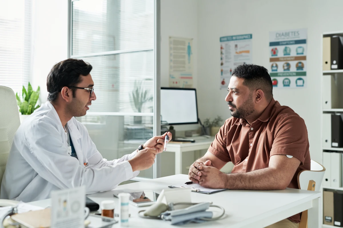 Doctor discussing signs of erectile dysfunction in men with patient.