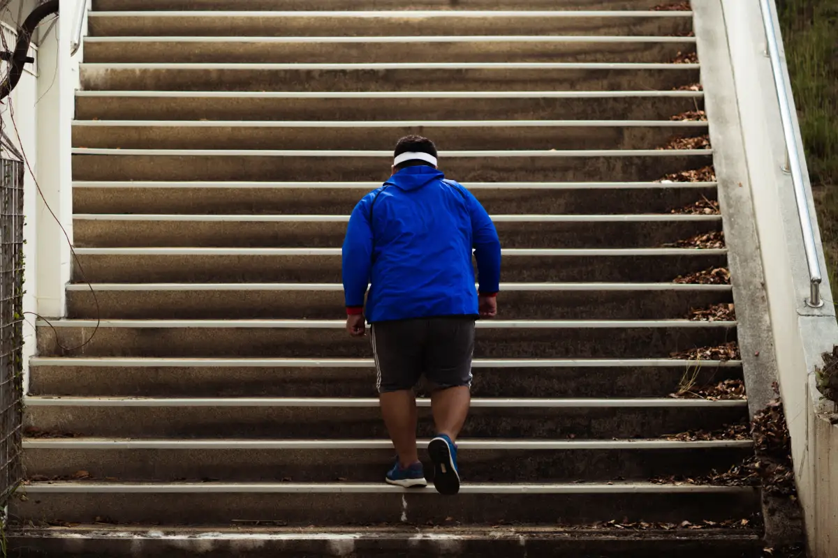 Man exercising on stairs to improve fitness, build healthy habits, and support sustainable weight loss and long-term weight management.
