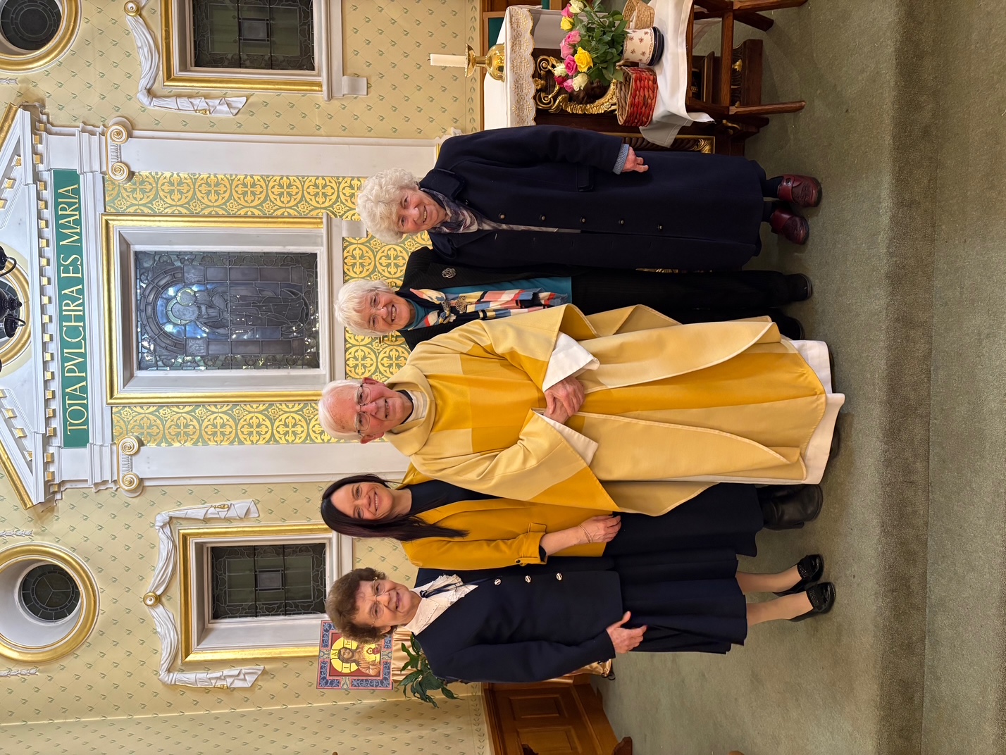 Mgr Daniel McHugh with Professor Alan McClelland's wife and daughter