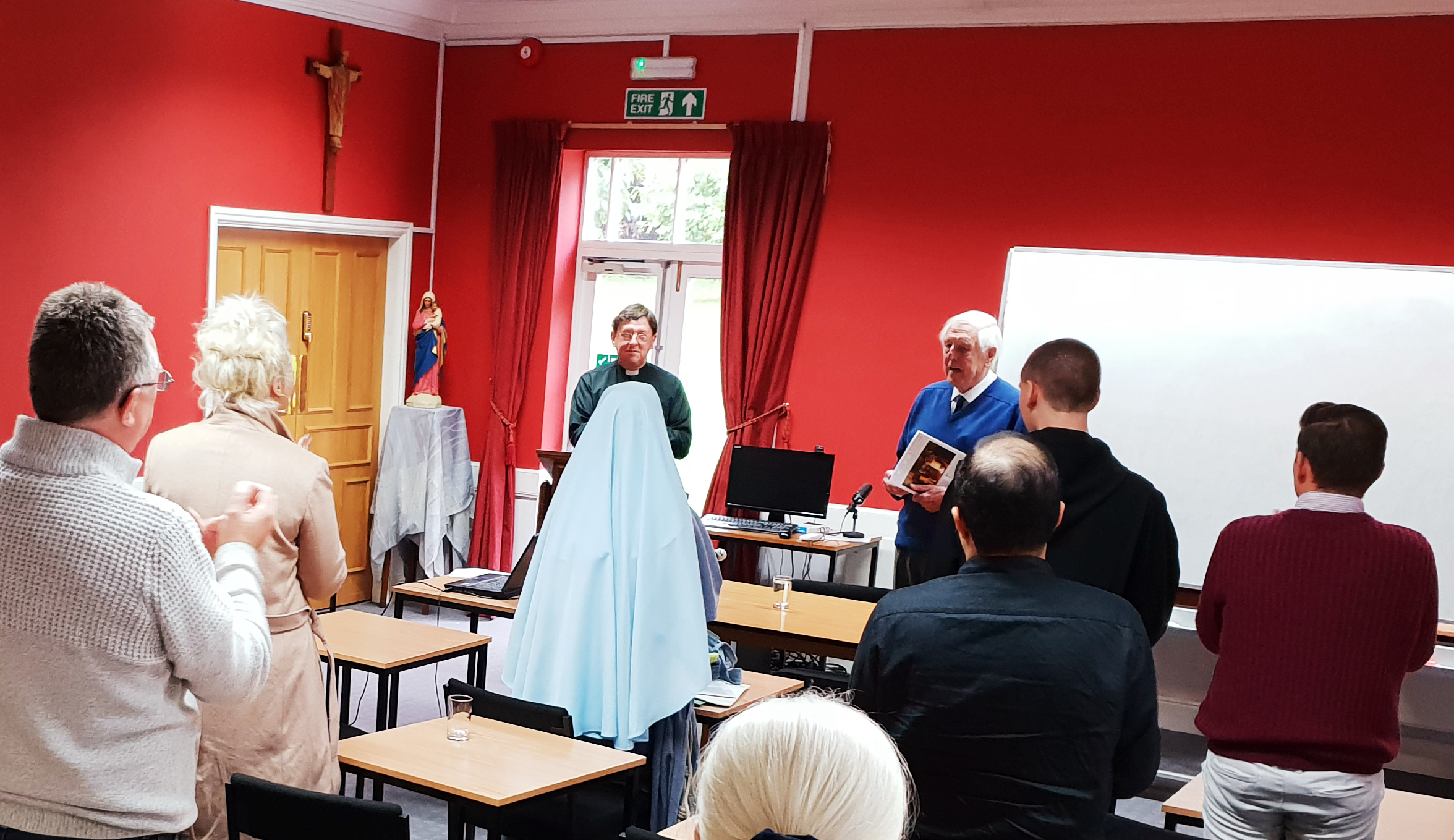Professor Jack Scarisbrick receiving applause from students after a lecture