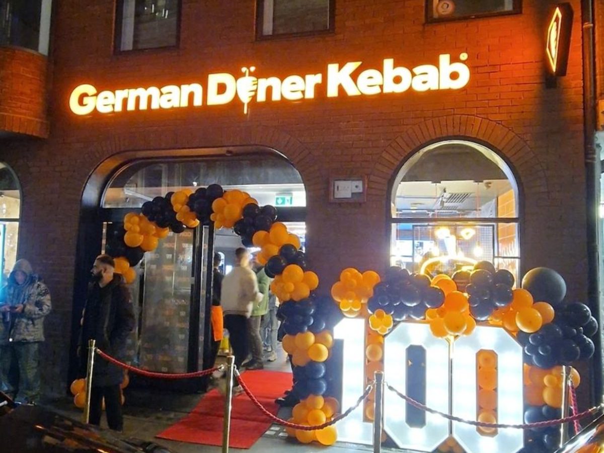 German Doner Kebab 100th UK store launch at night with red carpet and balloon numerals