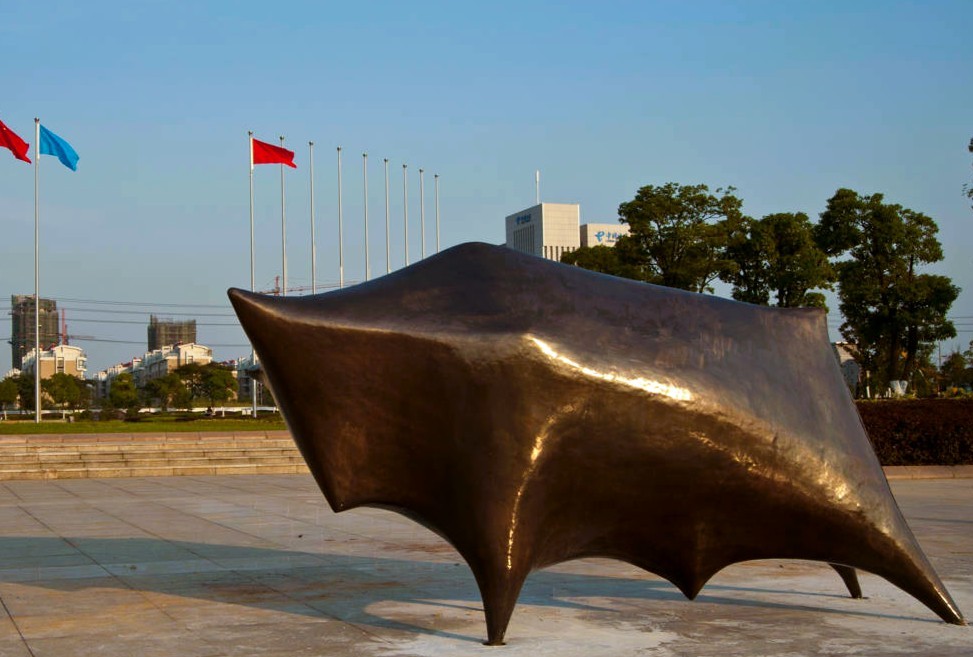 Side view of Bull, showing its horns and angular body.