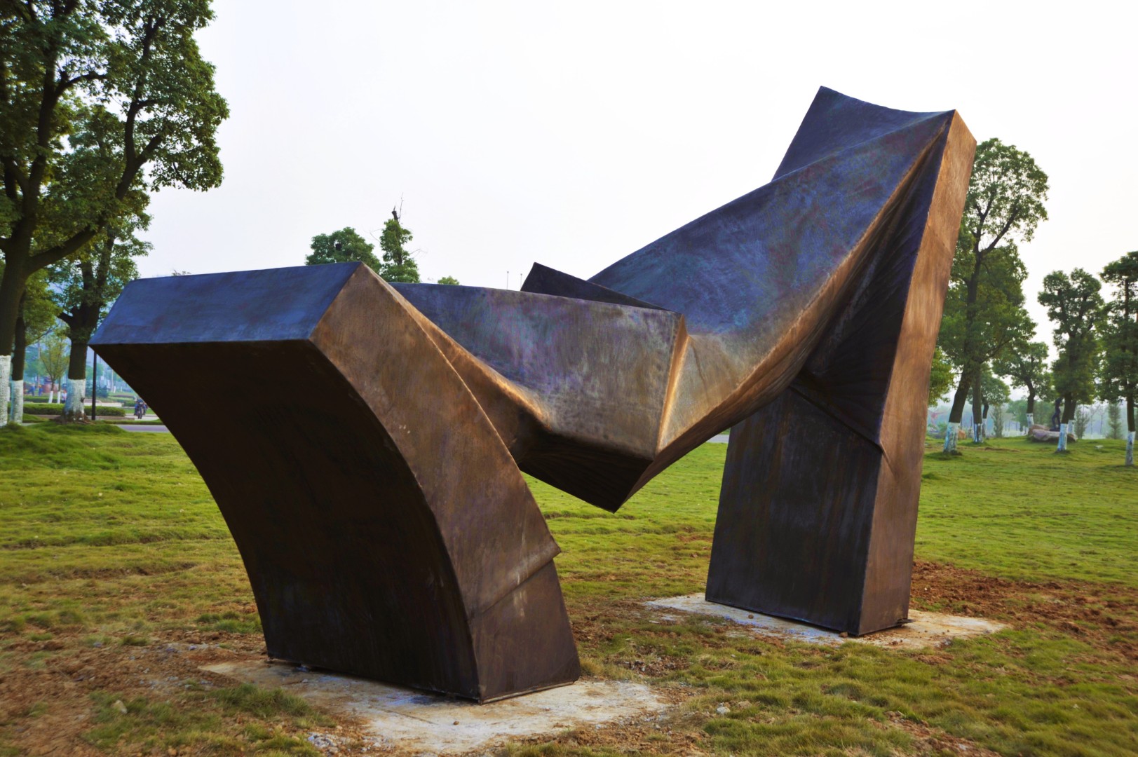 Angled view of the folded bronze forms of Get Power Back.