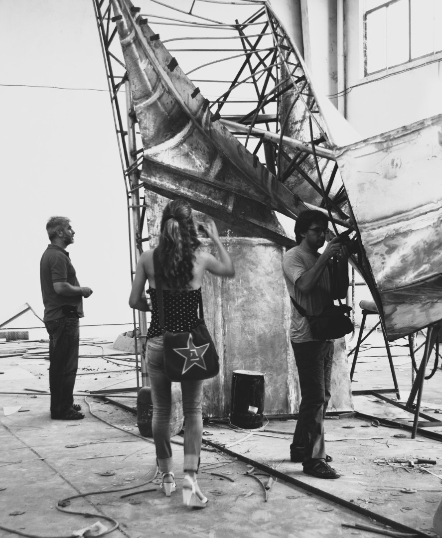 Workers beside the large metal framework of Get Power Back.