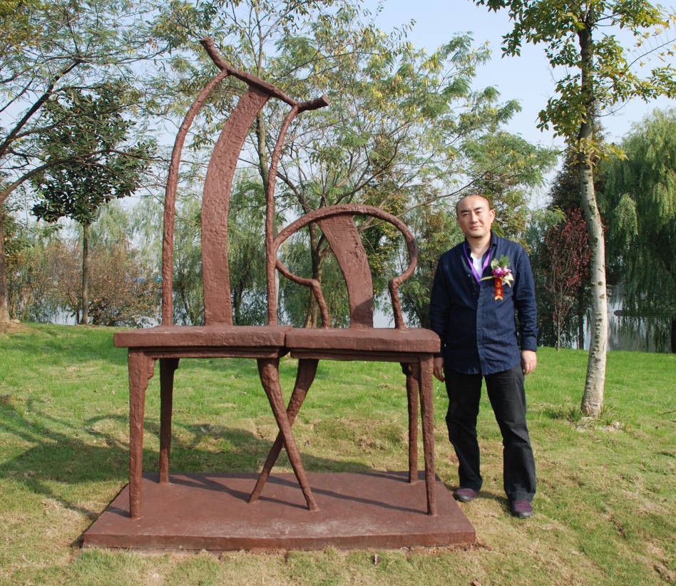A visitor beside Whisper shows the scale of the work.