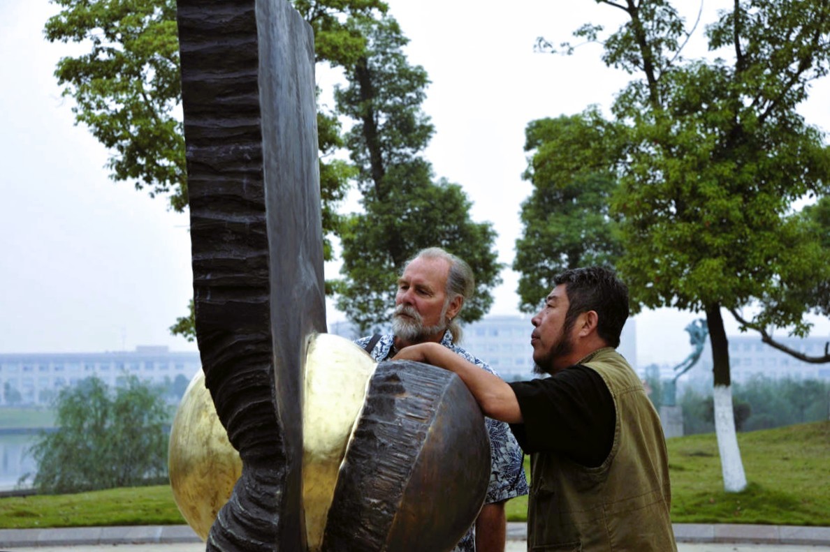 Sculptor working on Sphere in Slab