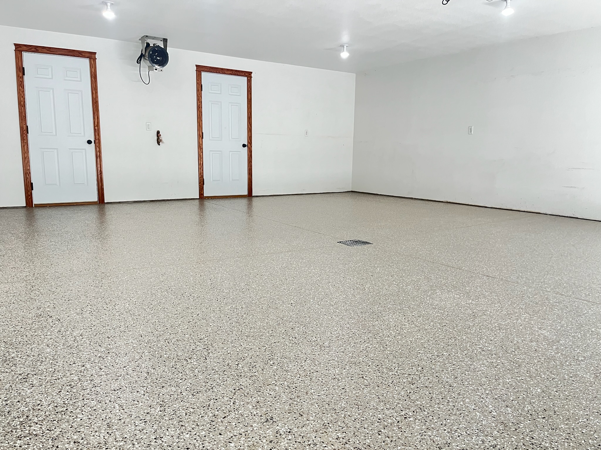Light tan full broadcast epoxy coated garage floor in Bismarck ND by Armour Floors