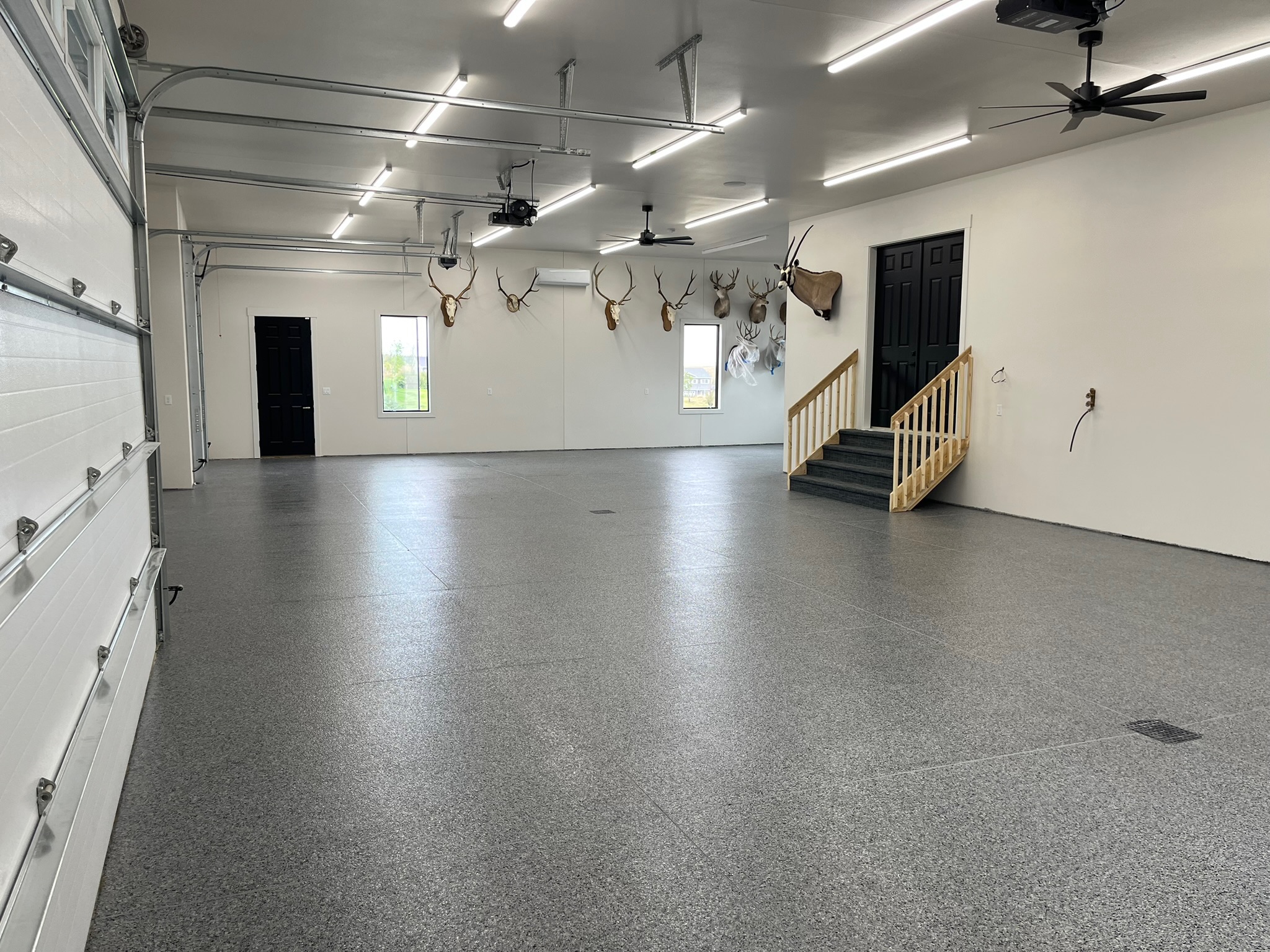 Large wide garage in Bismarck ND with finished full broadcast wombat flake epoxy floor coating