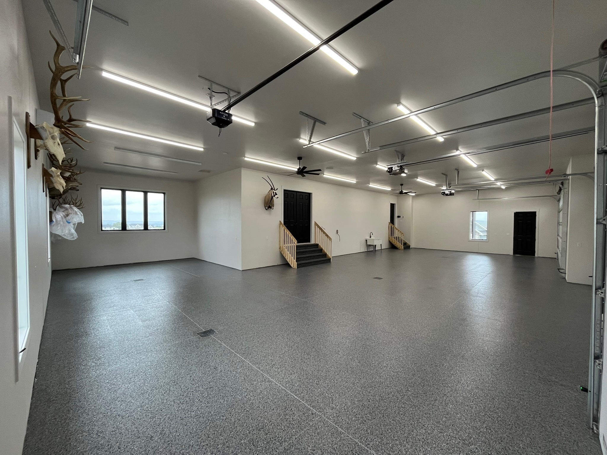 Large wide garage in Bismarck ND with finished full broadcast wombat flake epoxy floor coating