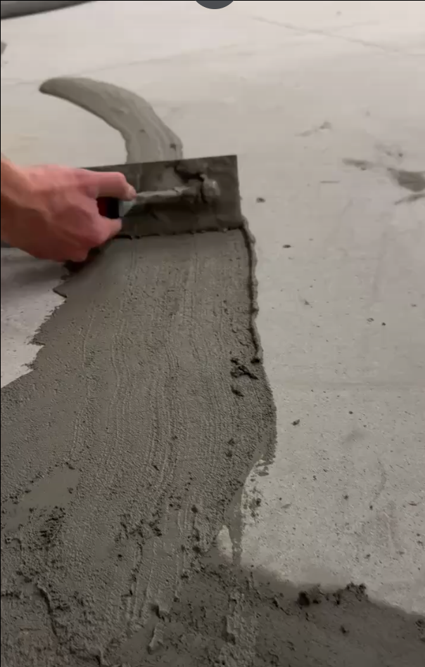 Patching cracks on an unprotected garage floor before coating installation