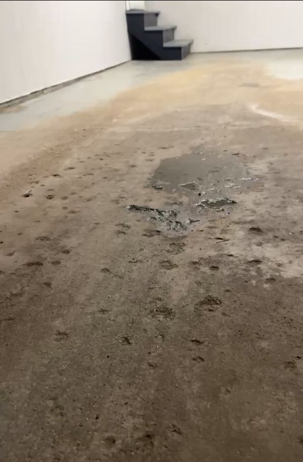 Pitting and surface deterioration on an unprotected garage floor before coating installation