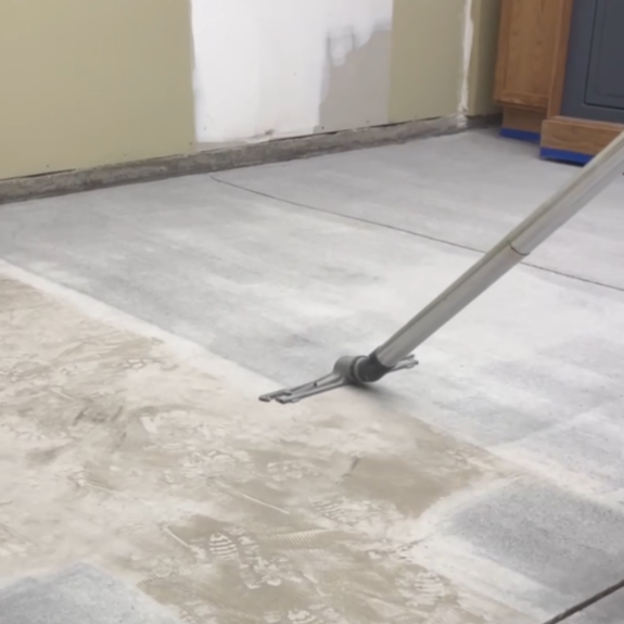 Vacuuming concrete floor to prepare the surface for maximum coating adhesion