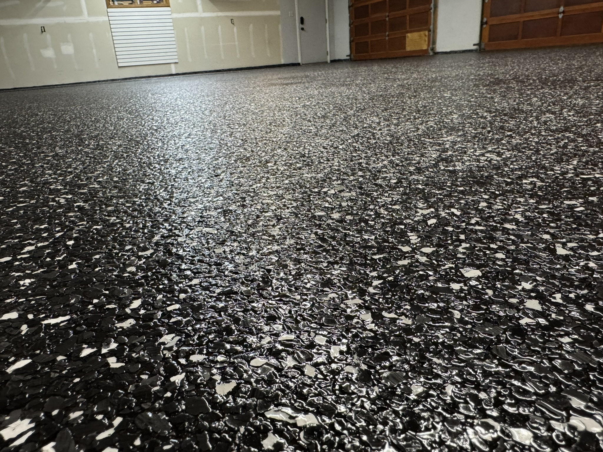 Close-up of a finished full flake garage floor coating installed by Armour Floors