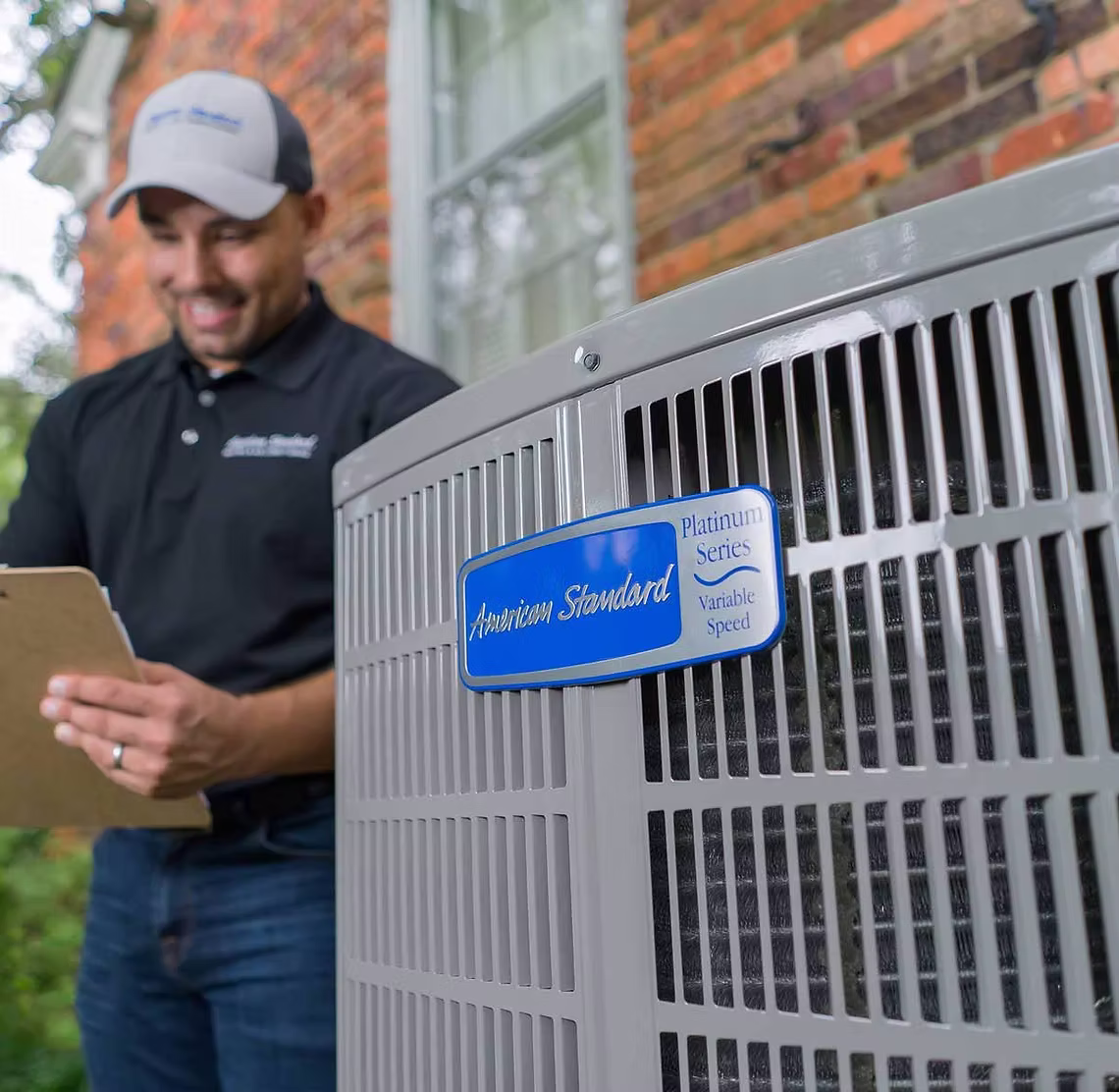 Beede technician performing AC maintenance on a Katy home