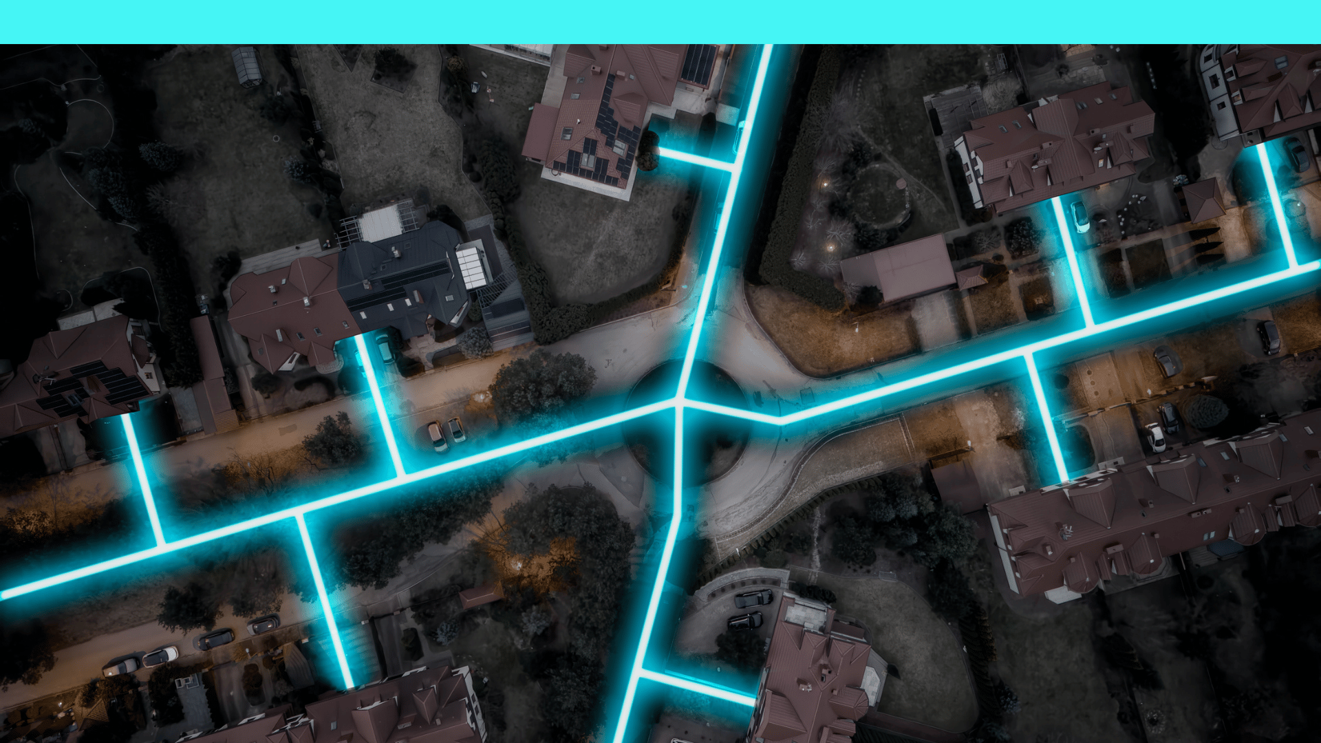 Aerial view of neighborhood streets and houses with glowing blue lines tracing roads and driveways.