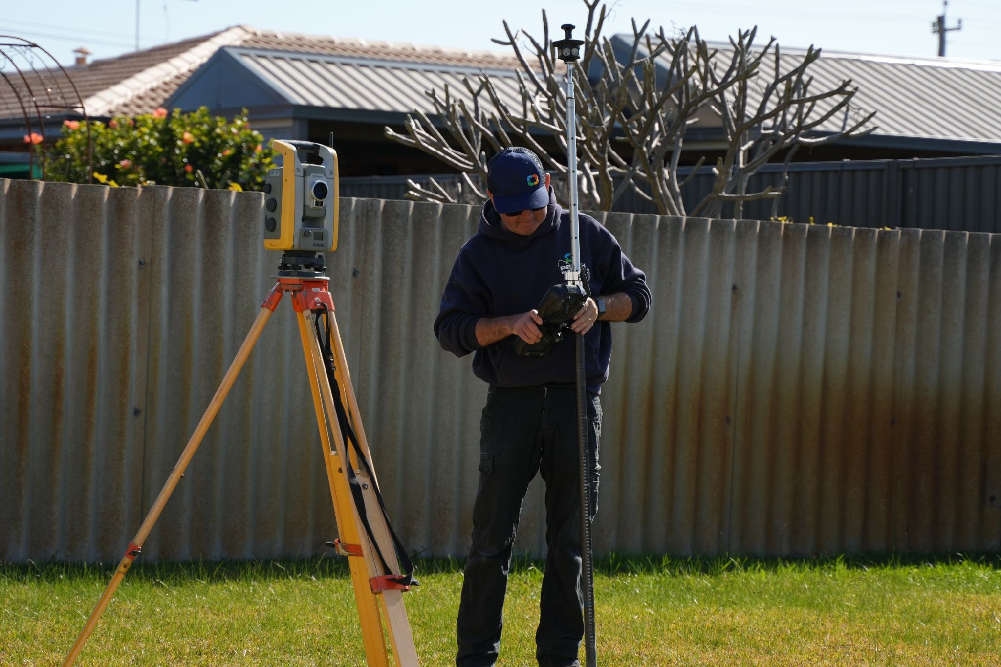 An image of a surveyor conducting a boundary survey within a home.