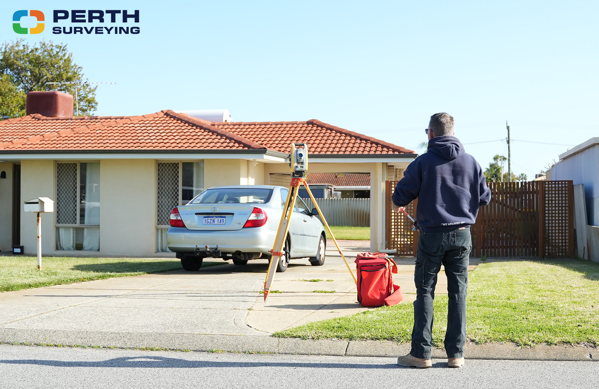 Perth Surveying team reviewing construction plans at a residential development site in Perth
