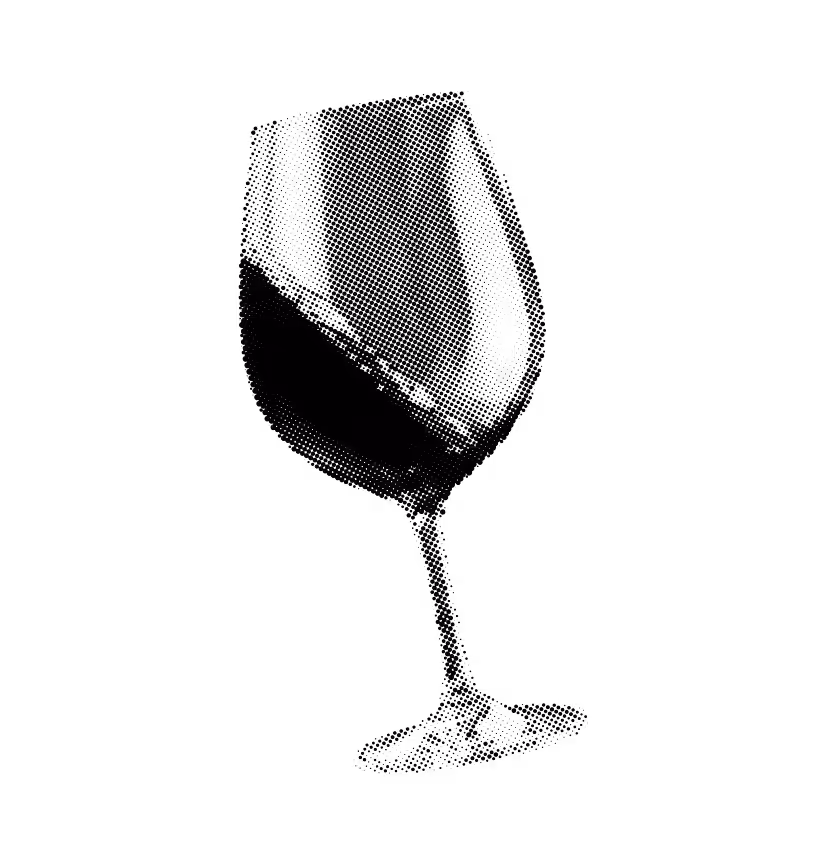 Wine glass tilted, filled with red wine against a black background.