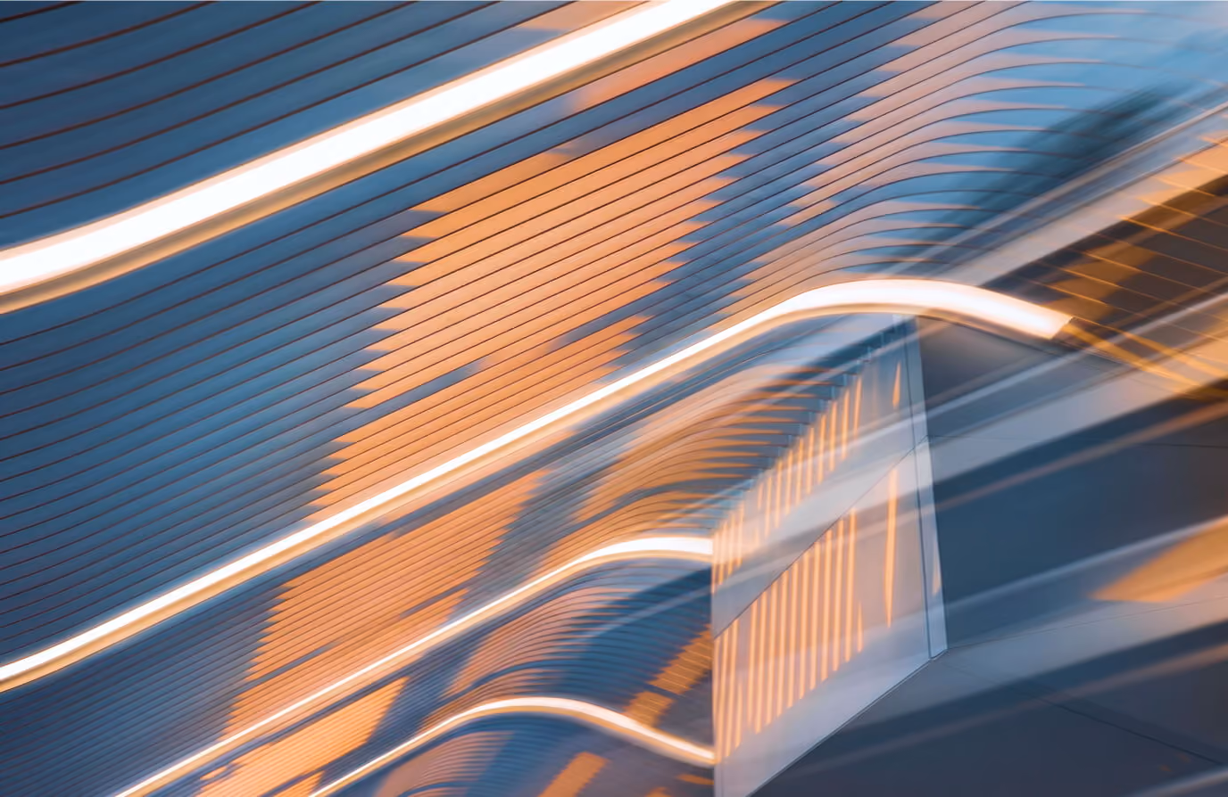 Abstract image of blue and orange linear patterns with curved white light streaks, resembling a modern architectural ceiling design.