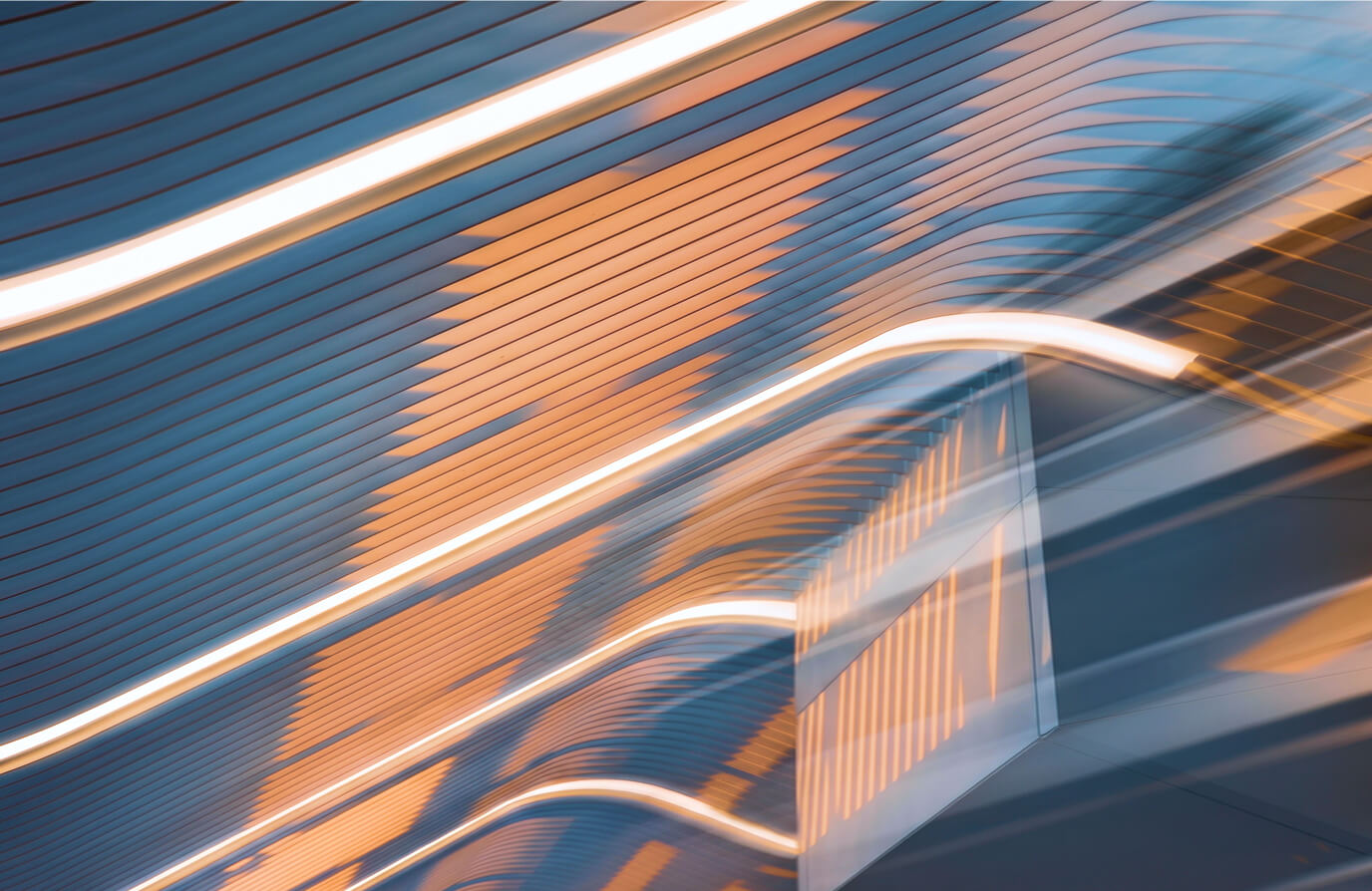 Abstract image of blue and orange linear patterns with curved white light streaks, resembling a modern architectural ceiling design.