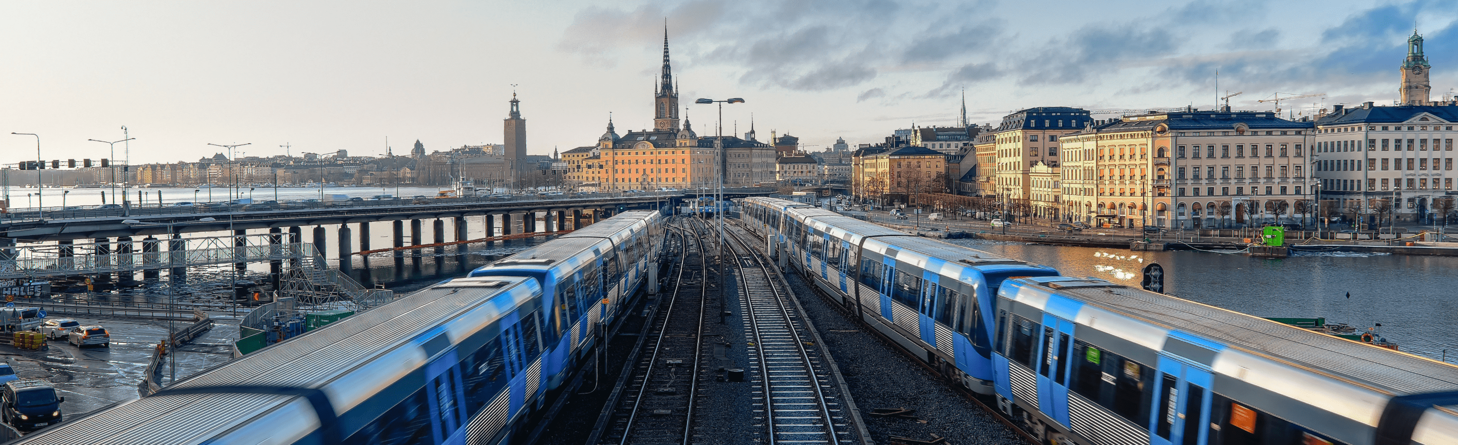 Two trains with the background of the panorama of Stockholm city, symbolizing Fieldstream's Swedish roots