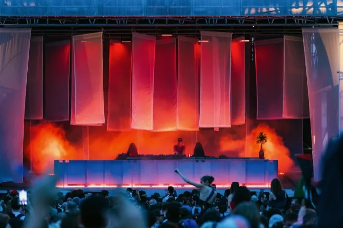 GALA — Joy Main Stage, hanging drapes lit red above the crowd
