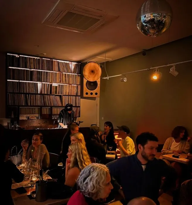 Jazu Hi-Fi Sound Bar — warm room, records wall and mirrorball