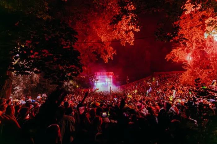 We Out Here — The Grove stage under a red-lit forest canopy