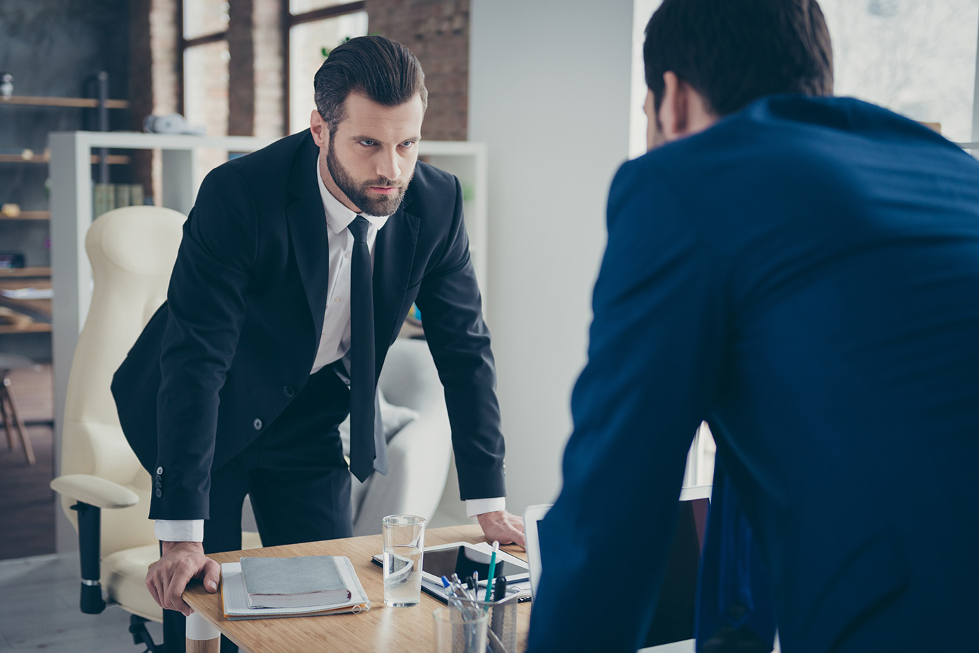 Manager discussing leadership and management styles with employees
